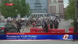 The first demonstrators arrive at RI State House in Providence protest