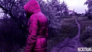 A progressive creature in black leather leggings, red shiny down jacket with hood and a gas mask