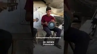 Children in war-ravaged Gaza learn music and singing inside a small tent