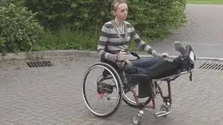 Pretty British woman crippled by an accident changing wheelchairs.