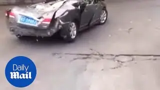 Driver calmly drives FLATTENED car to a repair shop!