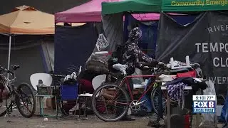 Police patrolling area where homeless encampment was