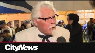 Colonel Sanders lookalike behind home plate at Blue Jays game