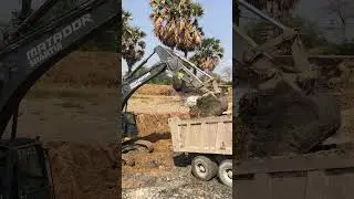 Matador Machine ME380 Excavator uploading to dump truck on construction.
