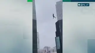 Rigger entangled in a tagline dangling from a crane at a Toronto construction site