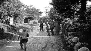 United States 7th Division infantrymen search entrances of native huts in Kin vil...HD Stock Footage