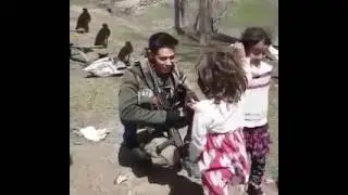 Turkish Soldiers And Syrian Children.