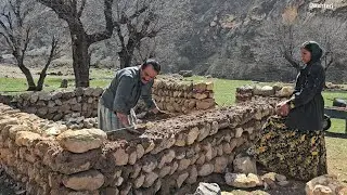 Leila and Hassan are happily working on the roof of the mountain hut.
