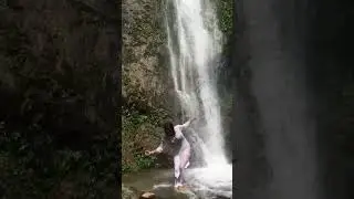 Girl taking bath in waterfall
