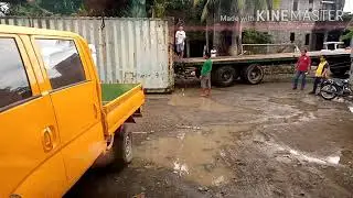Transfer of container van using backhoe