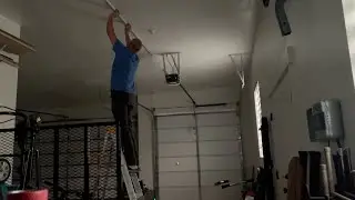 Hanging Barrina Amazon LED garage lights using a laser