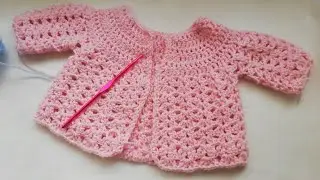 Crochet baby cardigan left hand by Crochet Nuts.  Dc yoke with shell pattern