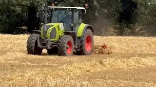Turning straw with the old hay bob .stacking some wet bales .
