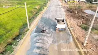 A dump truck is filling the drains near the escalator. 320B came to help