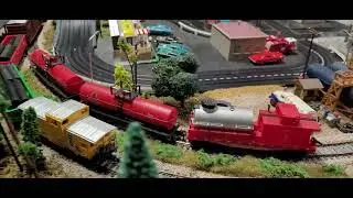 My home town ho scale t-jets and trains layout. AC Cobra cruising around town.