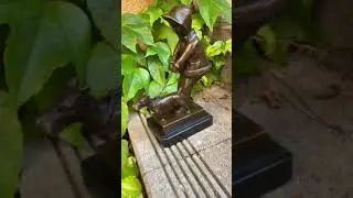 Bronze statue of a girl walking the dog