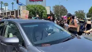 Car drives through LGBT BLM protesters LA