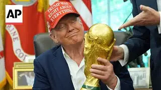 Trump holds the World Cup trophy and receives ticket to the final