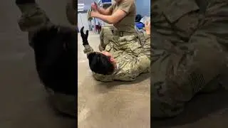 Female soldier teaches how to baseball choke