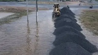 Motor Grader Clearing Gravel Coverage The Road In Village With 25T Dump Trucks