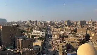 Aerial panning view Cairo cityscape panorama with apartment buildings in calm area and cars driving