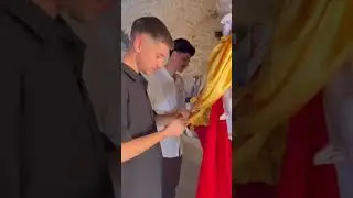 A Yazidi young man offers prayers at the sacred Lalish Temple
