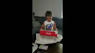 Kid unwraps Nintendo Switch for his birthday