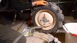 Removing liquid ballast from tractor tires with a pneumatic diaphragm pump