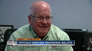 Officials verifying provisional ballots