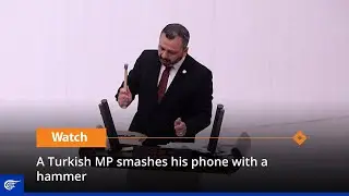 A Turkish MP smashes his phone with a hammer