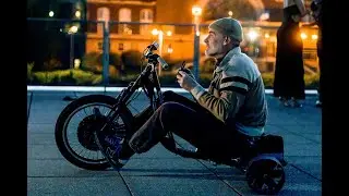 Electric drift trike takes to the streets outrunning goofy cop.