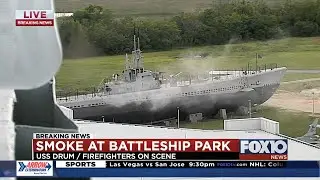 Fire officials on the scene of a commercial fire at Battleship Park