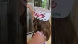Elianna explains the Krispy Kreme donut factory conveyor belt.