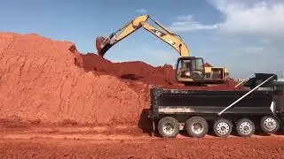 Loading trucks in cat 320 c l excavator!