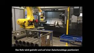S&&Uuml; Robotertechnik: Roboter mit Magnetgreifer zur Beschickung einer Drehmaschine