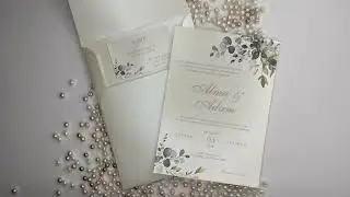 Beautiful ivory, gold and green botanical wedding invitation card and envelope with a classic touch.