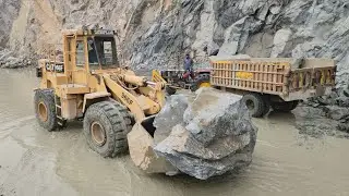 Caterpillar 966F Showing Raw Power in Mountain Area: Loading Big Rocks into Big Trolleys