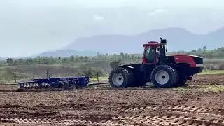 KAT KR Tractor 4404 in Cambodia, working with heavy duty disc harrow and 7 meter scraper.