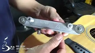 Adjusting bone saddle height on acoustic guitar by nut saddle sander