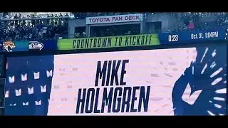 Mike Holmgren raising The 12th Man Flag.