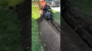 Ditch Witch trencher attachment in action