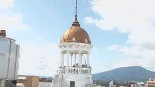 240 feet up: Man scales flagpole for repair on The Dome Building