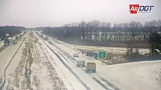 Arkansas: Tractor Trailer Flips Off Interstate After Hitting Patch Of Snow & National Guard Arrives