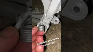 Reinstalling a foot peg spring on a 1986 Kawasaki kx80 motorbike