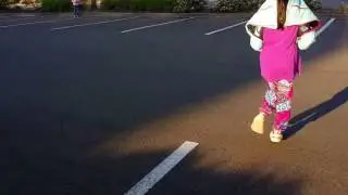 Toy RC plane flying through girl's legs just at the right time