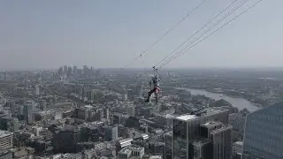 BBC reporter zip lines between London skyscrapers