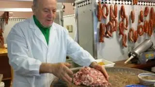 Chopping pork for sausage at Macelleria Salumeria Pennisi, Linguaglossa, Sicily, 2017-04-09