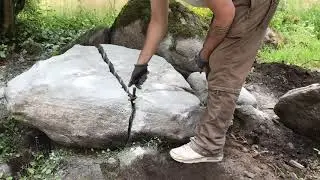 Splitting a big flat granite boulder.