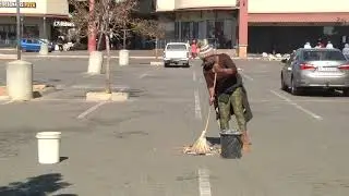 Members of the community conducting a clean up effort of the Diepkloof Mall in Soweto