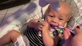 Four months old tries baby cereal for the first time